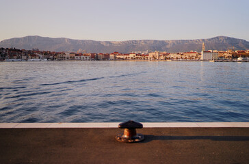 Iron bollard for mooring of ships at pier. Landscape with sea wharf. Split, Croatia.