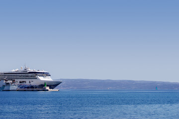 Ferryboat loading or unloading by a port pier. Concept of transportation and traveling.