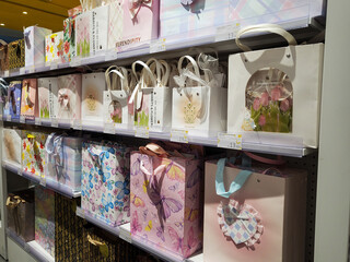 Various paper gift bags in different colors and patterns