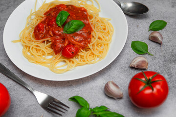 Flat Lay of Delicious Spaghetti Napoli with Fresh Tomatoes, Garlic, and Basil