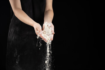 Cook pouring wheat white flour, hands close-up, copy place for text.