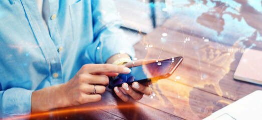 Close-up photo of female hands with smartphone. Concept of networking or remote work. Global business network.