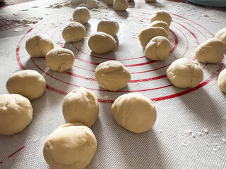 Small balls of fresh homemade dough  on floured