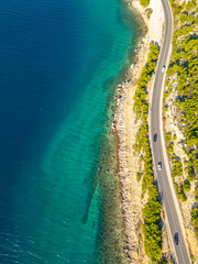 Aerial vertical view of curve road along the seashore at Dalmatia, Croatia. Beautiful sea coast and...