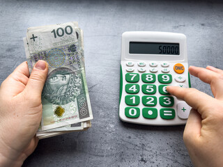 man count zloty and work with calculator.  Business and financial concept PLN