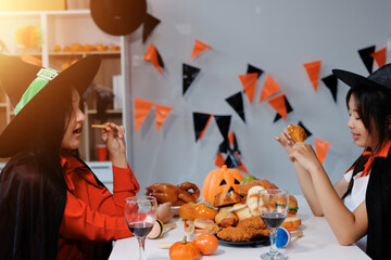 friendship, holiday and people concept - group of happy smiling friends in halloween costumes of...