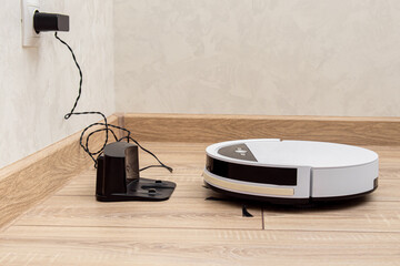 Robot vacuum cleaner returns to the charging station. Wired charging base