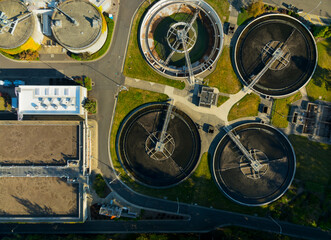 A view of a water treatment plant with three large tanks