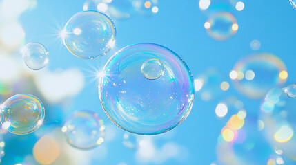 Soft soap bubbles floating in a bright blue sky