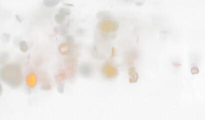 Blurred lights create an abstract colorful transparent background.