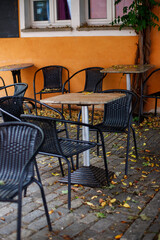 cafe on the street in autumn tables and chairs near the building in october autumn mood
