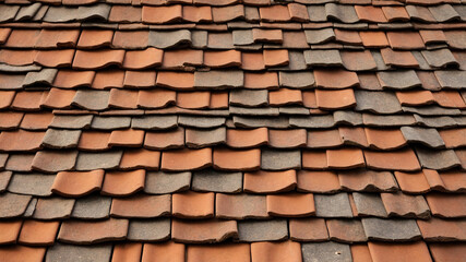 Traditional terracotta roof tiles with unique shape, creating an intricate pattern and earthy appeal.