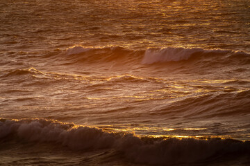 Wind waves in the baltic sea, storm at sea at sunset