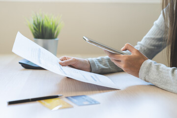 Bill pay concept. Online internet banking asian young man hand holding invoice use mobile smart...