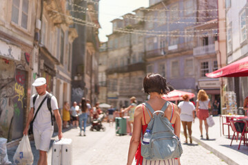 Female tourist walking through the city of Porto