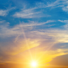 Bright orange sun against blue sky.