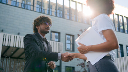 African American woman girl real estate manager trader saleswoman female realtor give bunch of keys to male client businessman customer man business rent delivery property in city buying apartment