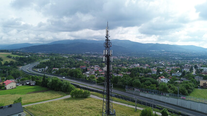 5G Telecommunications tower above rural town and highway