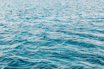 A detailed close up view of a tranquil body of water featuring waves