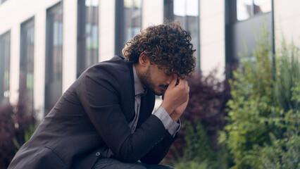 Tired stressful worried bad feeling frustrated Indian businessman Arabian sad upset Hispanic...