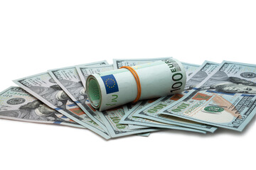 A rolled stack of euros stands surrounded by fanned out hundred dollar bills, symbolizing financial diversity and global economy.