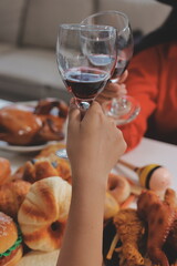 friendship, holiday and people concept - group of happy smiling friends in halloween costumes of vampire, devil, witch and cheetah at home party