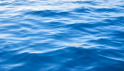 a serene blue water background with gentle ripples reflecting sunlight