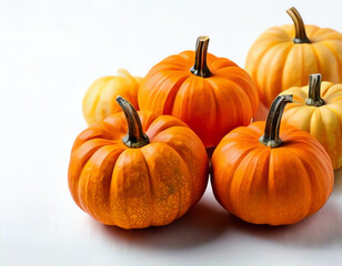 Obraz premium small decorative pumpkins on a orange background with space for text