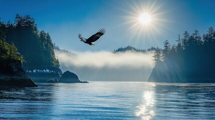 An eagle soars through the mist, with the sun shining through the clouds and reflecting off the water, in a beautiful scenic landscape.