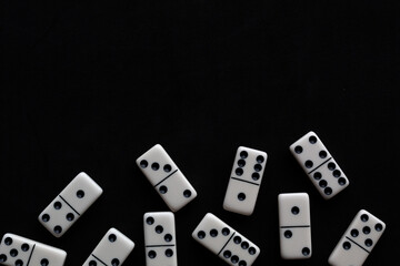 Domino tiles on black background with space for text.