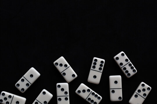 Domino tiles on black background with space for text.