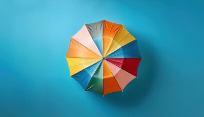 Overhead Top View of a Multicolored Umbrella on a Bright Blue Background. Ideal for Concepts of Summer, Creativity, Protection, and Playful Vibes in Marketing, Graphic Design, and Lifestyle Imagery