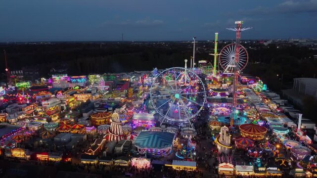 Drone. Hull Fair, Europe's largest travelling fun fair. Neon lights and rides from above.
