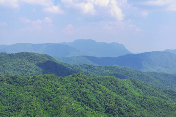 Naklejka premium Mountain landscape with white clouds covering the sky in Khao Kho District, Phetchabun Province, Thailand.