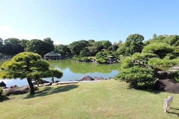 Dai-Sensui Pond, Ryotei House and Japanese black pine trees in Kiyosumi Garden, Tokyo, Japan