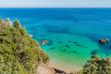 Fototapeta premium Aerial view of cliff with clear turquoise water at Ribeiro do Cavalo beach, Sesimbra PORTUGAL