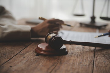Business and lawyers discussing contract papers with brass scale on desk in office. Law, legal...