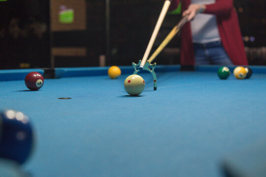 Young woman plays billiard