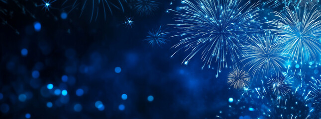 Blue fireworks against a dark blue sky background with copy space, a banner design. New year celebration concept.