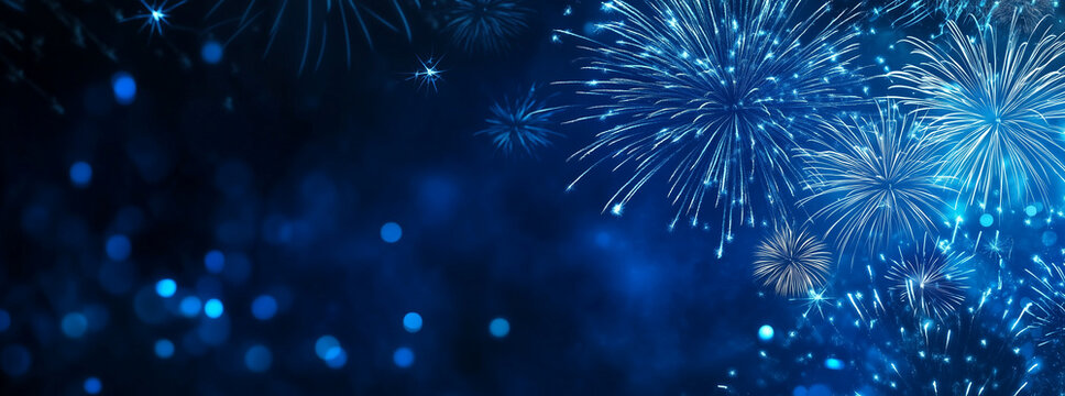 Blue fireworks against a dark blue sky background with copy space, a banner design. New year celebration concept.