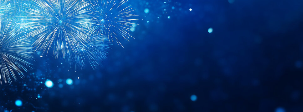 Blue fireworks against a dark blue sky background with copy space, a banner design. New year celebration concept.