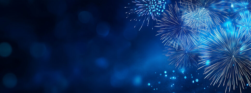 Blue fireworks against a dark blue sky background with copy space, a banner design. New year celebration concept.