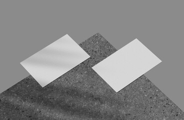 Two business card mockup on dark concrete block with shadow overlay