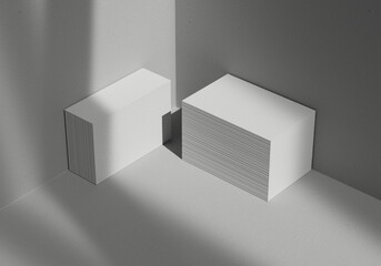 Two stacked business card mockup next to concrete wall with shadow overlay