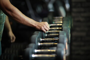 Fitness and healthy background concept. Dumbbells with blurred gym or sport club background at sunset. Picture for add text message. Backdrop for design art work