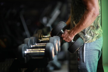 Fitness and healthy background concept. Dumbbells with blurred gym or sport club background at sunset. Picture for add text message. Backdrop for design art work.