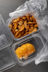 Takeaway food. Fast food from a store or cafeteria in food containers. Studio shooting. Delivery of ready-made food..