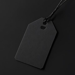 A blank black tag with a string, suitable for labeling or pricing items.