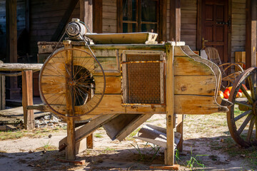 old wooden agricultural machine on a farm in western, wild west style. © Adam