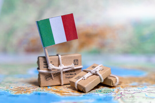 Flag of Italy near the parcels on the world map. World trade. Exports and imports of goods. Economy of the country.